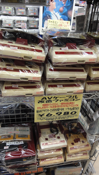 a stack of famicom game consoles for 6980 yen each